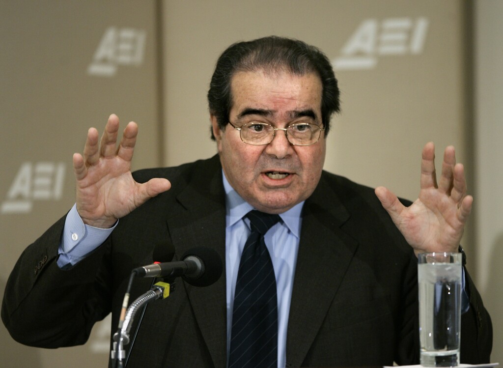 FILE - In this Feb. 21, 2006 file photo, Supreme Court Justice Antonin Scalia gives the keynote speech on the debate over the role that international and foreign law should play in American judicial decision-making, during a daylong symposium at the American Enterprise Institute in Washington. Dow Chemical says it will pay $835 million to settle a long-standing class action lawsuit, after the death of Scalia decreased its chances of prevailing at the Supreme Court. The company was found liable in 2013 by a Kansas jury for conspiring to fix prices for polyurethane, an industrial chemical. Dow had petitioned the Supreme Court to reconsider the judgment. (AP Photo/J. Scott Applewhite, File)