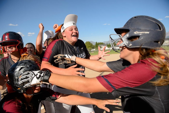 (Trent Nelson | The Salt Lake Tribune)
Herriman players celebrate a win over Syracuse in the 6A Softball State Championship game, Thursday May 24, 2018. At right is Herriman's Cassidy Adams (7), who drove in the winning run.