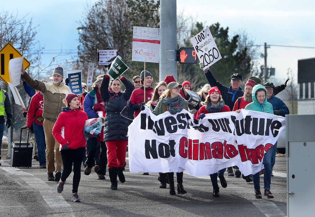 Scott Sommerdorf   |  The Salt Lake TribuneEnvironmental activist demonstrators joyously ran across 4500S prior to blockading an Exxon station in Murray with red lines meant to symbolize Exxon's closure. Activists demand the closure as retribution for the company's alleged role in denying climate change, Saturday, December 12, 2015.