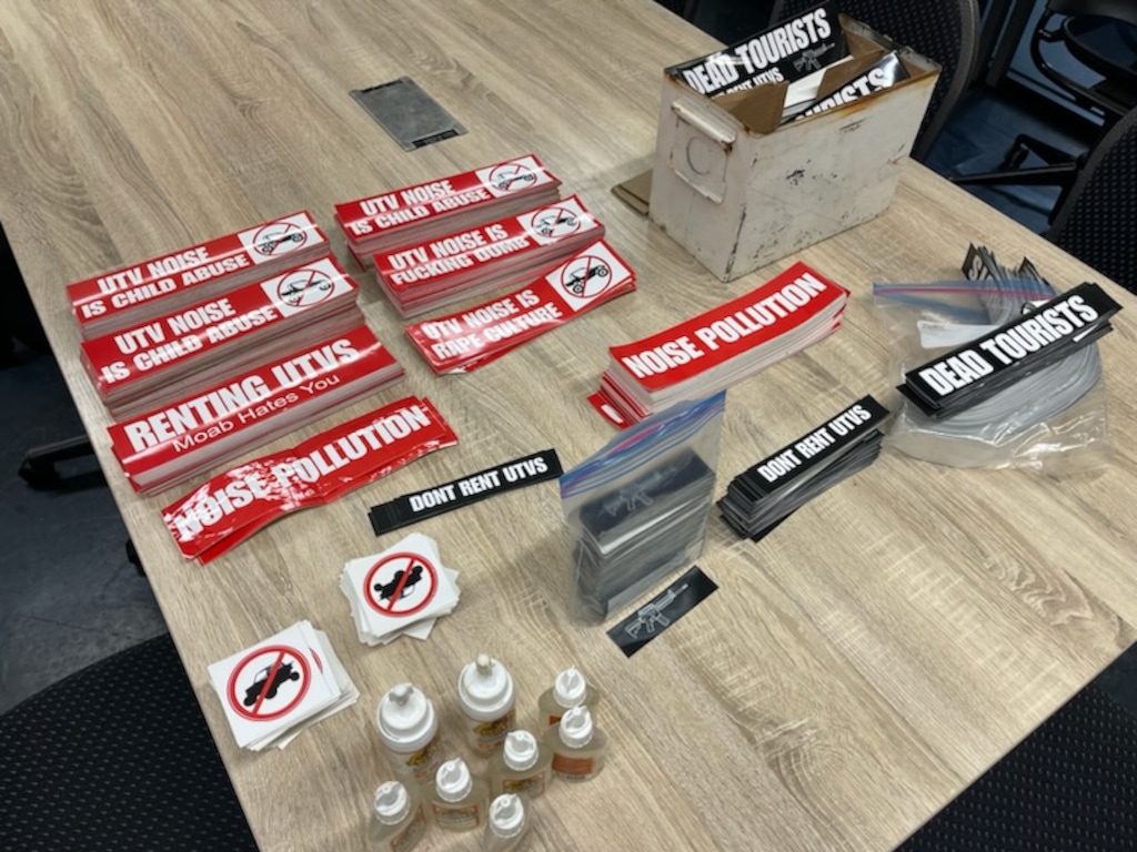 (Moab Police Department) Stickers that the Moab Police Department says they found inside the man's house after a search.