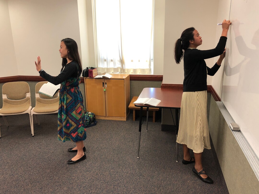(Mike Stack  |  for The Salt Lake Tribune) Filipino LDS Missionary Shairyl Arago leads music as her companion Michelle Joy Rodriquez writes on whiteboard in an Everyday branch in central Hong Kong.