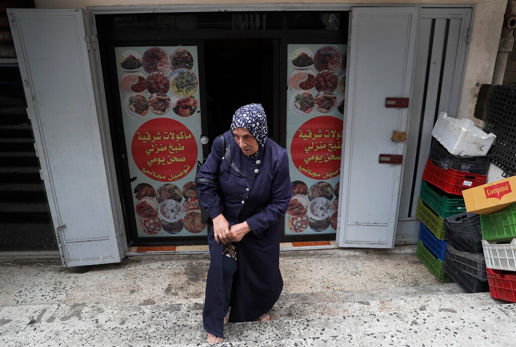 (Hussein Malla | The Associated Press) In this Saturday, June 30, 2018, photo, Dahouk al-Omar, 68, an unregistered Syrian refugee, who is hoping she can join her son now resettled in U.S, Chicago state, leaves a catering business where she works as a cooker, in Tripoli, north Lebanon. The Trump administration travel ban has thrown yet another obstacle in the way of Syrian refugees whose status in neighboring countries is already extremely uncertain.