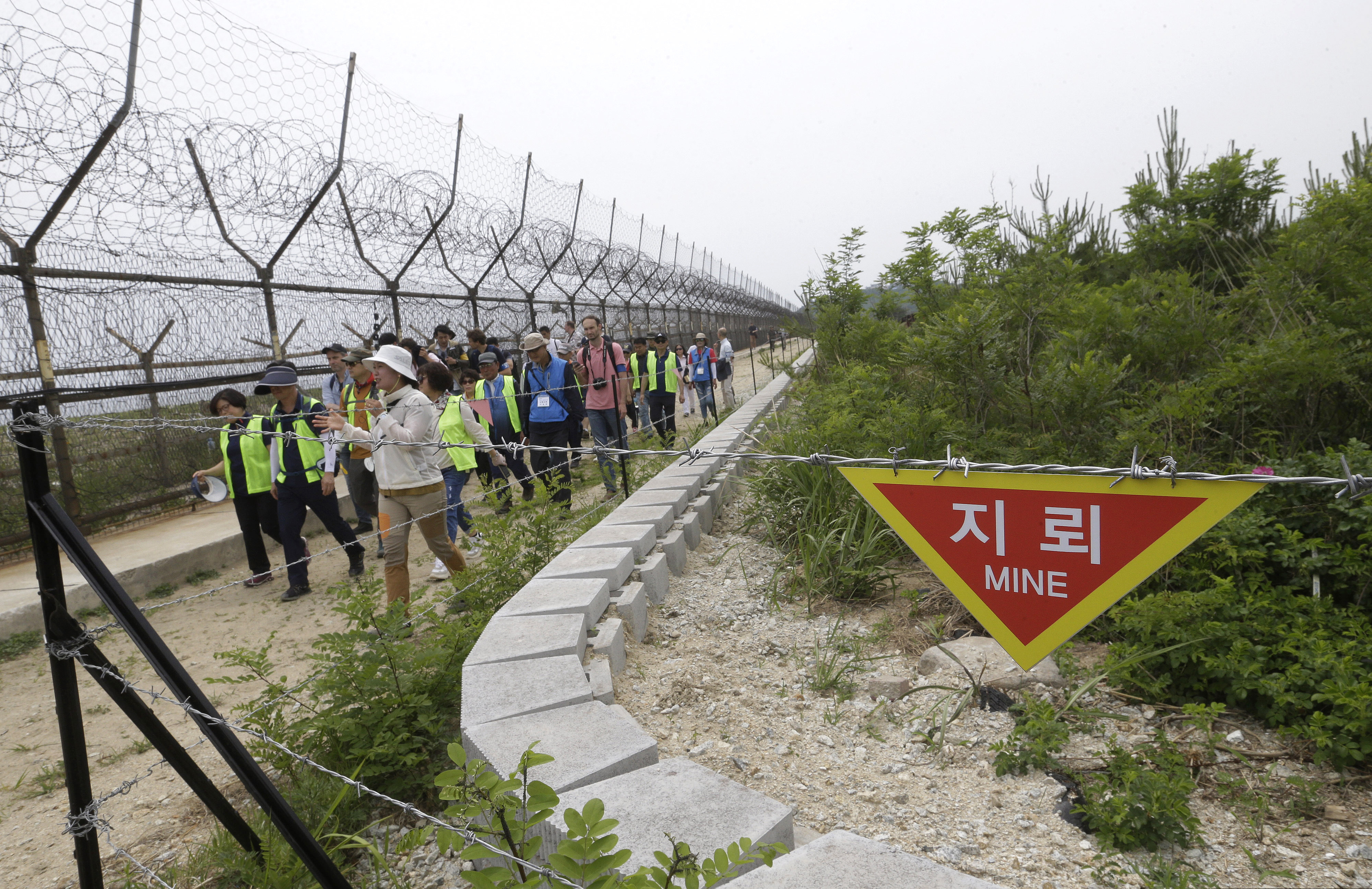(Ahn Young-joon | AP Photo) In this June 14, 2019 photo, hikers and journalists walk along the DMZ Peace Trail in the demilitarized zone in Goseong, South Korea. Eyeing a history-making photo opportunity, U.S. President Donald Trump on Saturday, June 29, 2019, issued a Twitter invitation to North Korea's Kim Jong Un to join him for a hand shake during a visit by Trump to the demilitarized zone with South Korea.