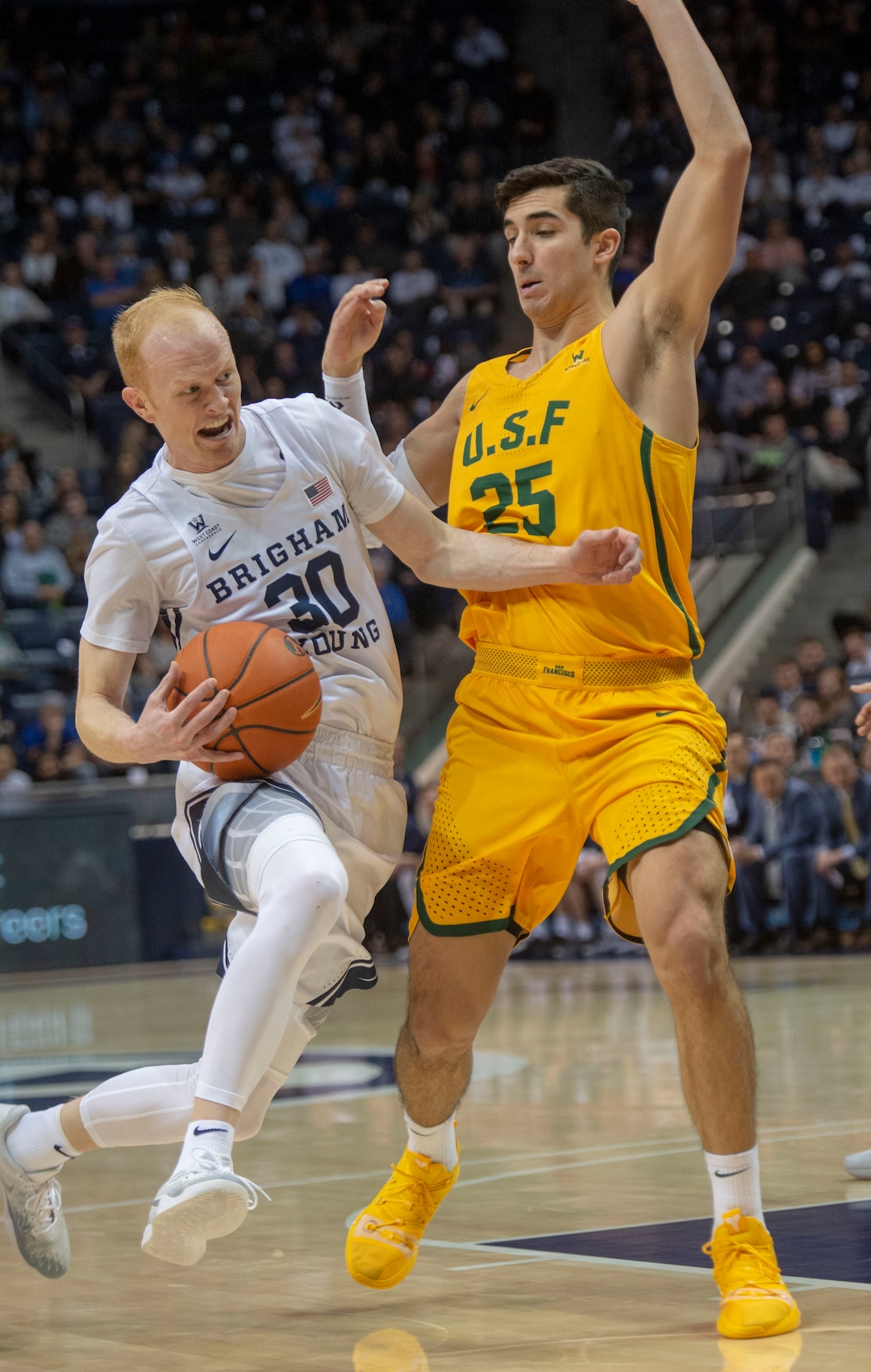 (Rick Egan  |  The Salt Lake Tribune)  Brigham Young Cougars guard TJ Haws (30) takes the ball inside as San Francisco Dons guard Jordan Ratinho (25) defends, in WCC basketball action at the Marriott Center, Thursday, February 21, 2018.