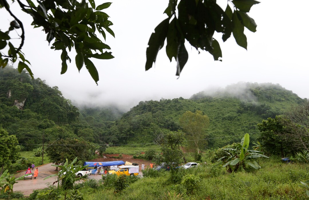 Vehicles are stopped at a checkpoint near the entrance to a cave complex where five were still trapped, in Mae Sai, Chiang Rai province, northern Thailand Tuesday, July 10, 2018. The eight boys were rescued from the flooded cave. (AP Photo/Sakchai Lalit)