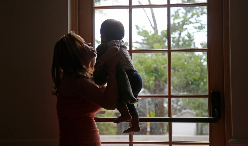 In this May 18, 2018, photo, Vicky Chavez plays with her daughter Issabella within the walls of the First Unitarian Church, in Salt Lake City. Vicky Chavez said Monday, July 9, at a news conference that she hopes to be a voice for other women who are victims of domestic violence. She fled San Pedro Sula, Honduras, in fear of an abusive boyfriend four years ago. (AP Photo/Rick Bowmer)