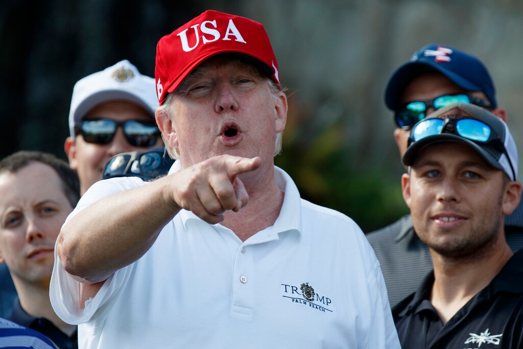 President Donald Trump speaks as he meets with members of the U.S. Coast Guard, who he invited to play golf, at Trump International Golf Club, Friday, Dec. 29, 2017, in West Palm Beach, Fla. (AP Photo/Evan Vucci)
