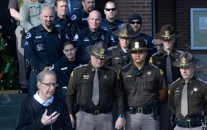 (Al Hartmann | The Salt Lake Tribune) Members of the South Jordan Police and Utah Highway Patrol stand with Mike McMillian, left, on Thursday, Dec. 14, 2017. He described their family's loss when a drunk driver, who was driving the wrong direction on I-215, killed their adult son, Mikey, in 2015. South Jordan Police and the Utah Highway Patrol said that there will be increased patrols and enforcement over the holiday to catch drunken drivers.
