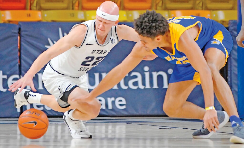 Utah State guard Brock Miller (22) and San Jose State forward Chase Courtney scramble for the ball during the first half of an NCAA college basketball game Monday, Dec. 21, 2020, in Logan, Utah. (Eli Lucero/The Herald Journal via AP, Pool)