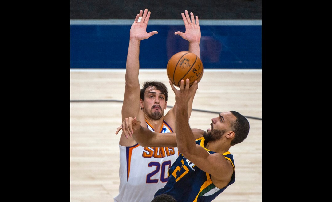 (Rick Egan | The Salt Lake Tribune) Utah Jazz center Rudy Gobert (27) shoots as Phoenix Suns forward Dario Saric (20) defends, in NBA action between the Utah Jazz and the Phoenix Suns, on Thursday, Dec. 31, 2020.
