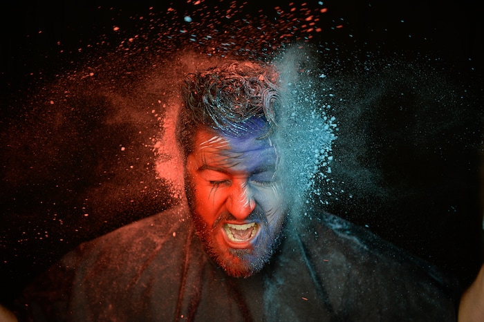 (Francisco Kjolseth | The Salt Lake Tribune) BYU and Utah fan alike Brad Klekas of South Jordan shows his mutual admiration by stepping into the Tribune studio to get both colors in anticipation of the upcoming match up between the two rival teams on Saturday.