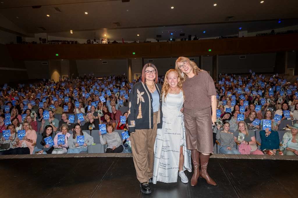 (Tom Gallo | GH Prime Media) Author Jodi Picoult, center, headlined the Salt Lake Book Festival with a talk at West High School on Saturday, Oct. 17, 2026. Attendees hold a copy of "Hollow Bones," her new novel. Picoult also surprised the crowd with free copies of "Nineteen Minutes," her novel banned from all Utah public schools.