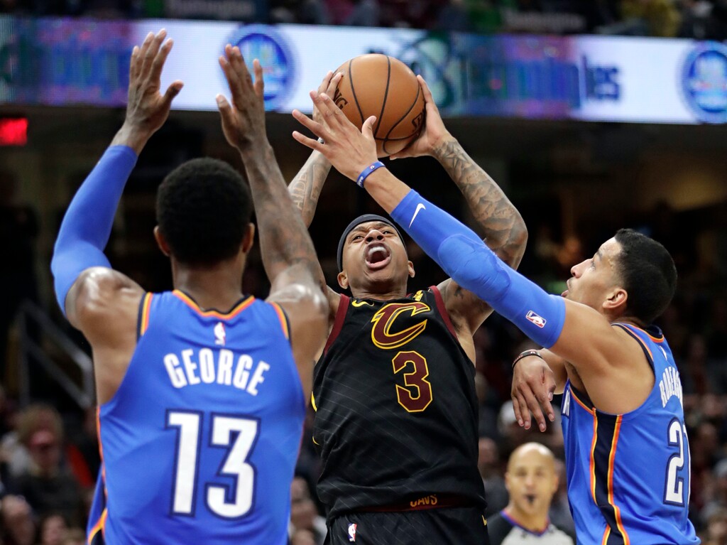 Cleveland Cavaliers' Isaiah Thomas (3) shoots between Oklahoma City Thunder's Paul George (13) and Andre Roberson (21) in the first half of an NBA basketball game, Saturday, Jan. 20, 2018, in Cleveland. (AP Photo/Tony Dejak)