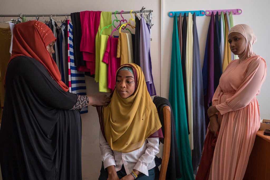 (Jordi Perdigo | Associated Press file photo)  A Ghanan woman helps a customer to set up a hijab inside her workshop in Accra, Ghana, in January 2018.