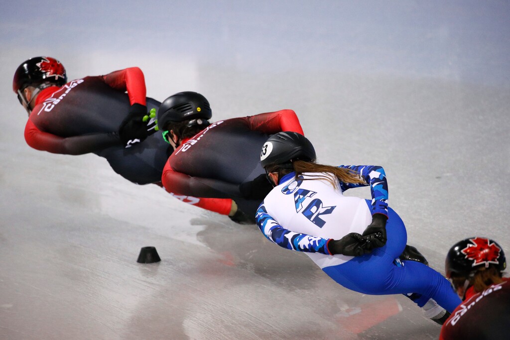FILE - In this Feb. 3, 2018, file photo, wearing an Olympic uniform with the logo OAR - Olympic Athlete from Russia, Russian short track speed skater Ekaterina Efremenkova rounds the track with Canadian skaters during a training session prior to the 2018 Winter Olympics in Gangneung, South Korea. As punishment for doping offenses at the 2014 Sochi Games, the International Olympic Committee has forced Russian athletes competing in Pyeongchang to do so as OARs in neutral uniforms and with no national insignia. (AP Photo/Jae C. Hong, File)