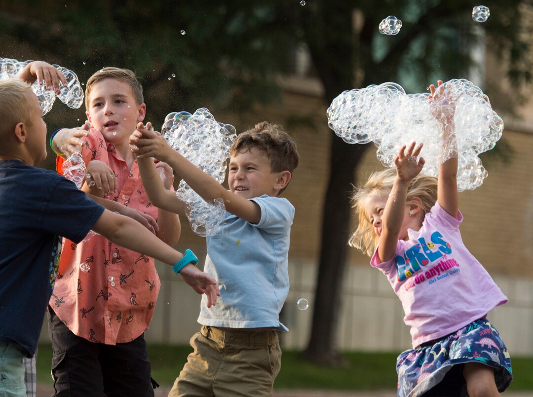 (Rick Egan  |  The Salt Lake Tribune)      Kids chase bubbles as they fall from the bubble tower at the Utah State Fair, Thursday, Sept. 6, 2018.