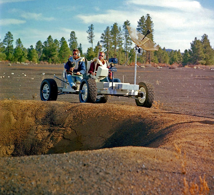(U.S. Geological Survey Astrogeology Science Center via AP) This undated photo provided by the U.S. Geological Survey Astrogeology Science Center shows Apollo 15 astronauts Jim Irwin, left, and Dave Scott driving a prototype of a lunar rover in a volcanic cinder field east of Flagstaff, Ariz. The rover, named Grover, now is on display at the science center.