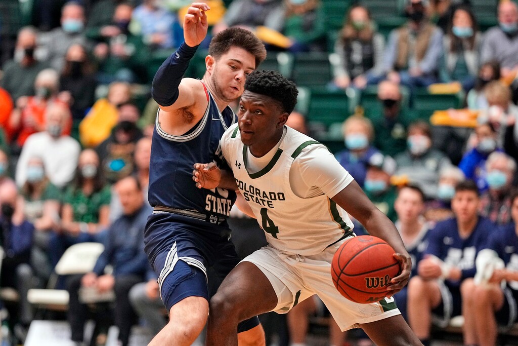 Colorado State guard Isaiah Stevens (4) bumps Utah State guard Rylan Jones (15) during the first half of an NCAA college basketball game Wednesday, Jan. 12, 2022, in Fort Collins, Colo. (AP Photo/Jack Dempsey)