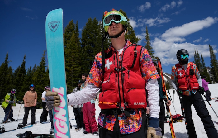 (Francisco Kjolseth  | The Salt Lake Tribune) Ski patroller Weston Keith joins the fun watching people attempt to skim the pond in Peruvian Gulch as Snowbird closes the book on the 2024-25 ski season on Monday, May 26, 2025. Snow and sun revelers took to the slushy slopes on Memorial Day as the resort was the last in the state to close.