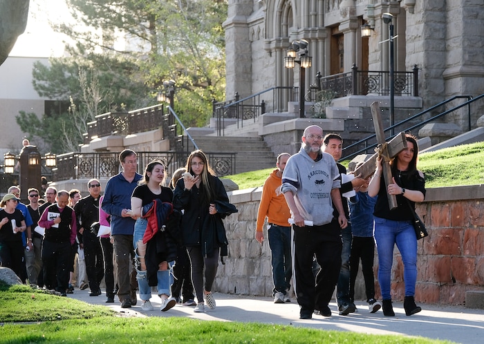 (Francisco Kjolseth  |  The Salt Lake Tribune)  Christians march through streets of Salt Lake City on Good Friday to symbolically mark Jesus' carrying the cross to his crucifixion beginning at Cathedral of the Madeleine.