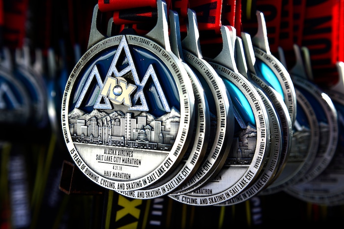 (Scott Sommerdorf | The Salt Lake Tribune)Medals await finishers in both the marathon and half marathon at the Salt Lake City marathon, Saturday, April 21, 2018.
