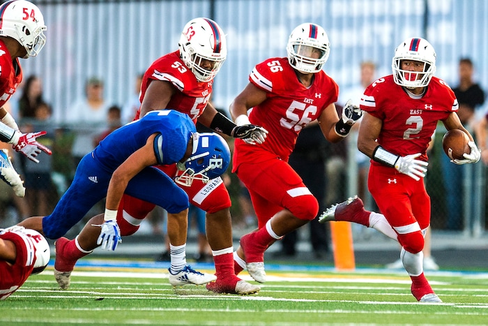(Chris Detrick  |  The Salt Lake Tribune)  East's Sione Molisi (2) runs past Bingham's Dax Milne (5) during the game at Bingham High School Friday, August 25, 2017. Bingham is winning the game 24-17 at halftime. 