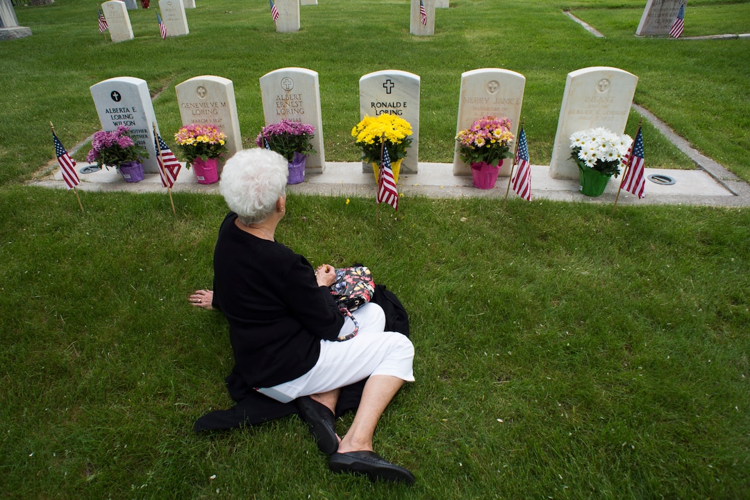 (Rick Egan  |  The Salt Lake Tribune)      Karen Keck, sit by the graves of her father, sister and brothers at the Fort Douglas Cemetery, after the Memorial Day observance Monday, May 28, 2018.