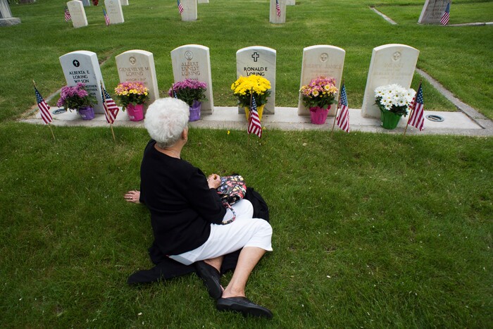(Rick Egan  |  The Salt Lake Tribune)      
Karen Keck, sit by the graves of her father, sister and brothers at the Fort Douglas Cemetery, after the Memorial Day observance Monday, May 28, 2018.


