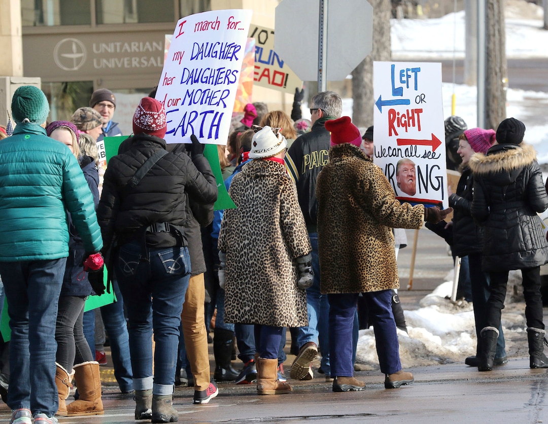 Hundreds march Saturday, Jan. 20, 2018 through downtown Eau Claire, Wis. as part of the Women's March Wisconsin Day of Action. The march followed a rally at Phoenix Park and was a companion event to marches in Milwaukee and Green Bay. (Steve Kinderman/The Eau Claire Leader-Telegram via AP)