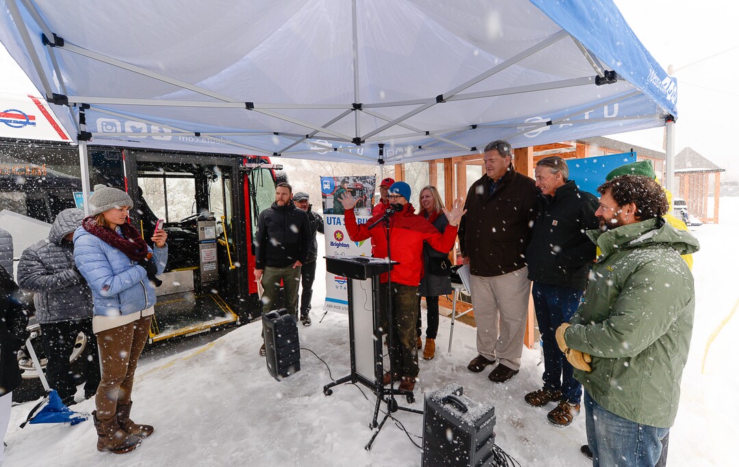 (Francisco Kjolseth  |  The Salt Lake Tribune)  UTA and Central Wasatch Commission members gather at the Big Cottonwood Canyon park and ride lot on Monday, Nov. 25, 2019, as the snow flies to remind residents about improvements to ski buses that will begin service on Nov. 29.