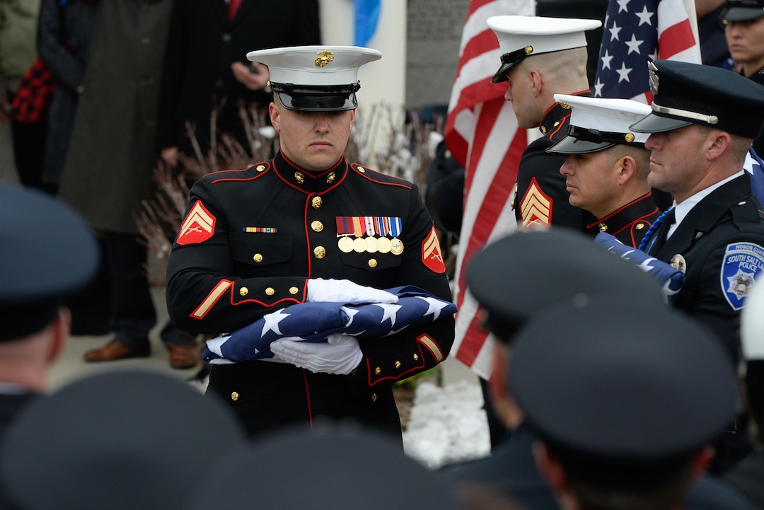(Francisco Kjolseth  |  The Salt Lake Tribune)  Members of the Marine Corps fold the flag draping the casket of police officer David Romrell during funeral services at Larkin Sunset Gardens Cemetery in Sandy, Wed. Dec. 5, 2018.