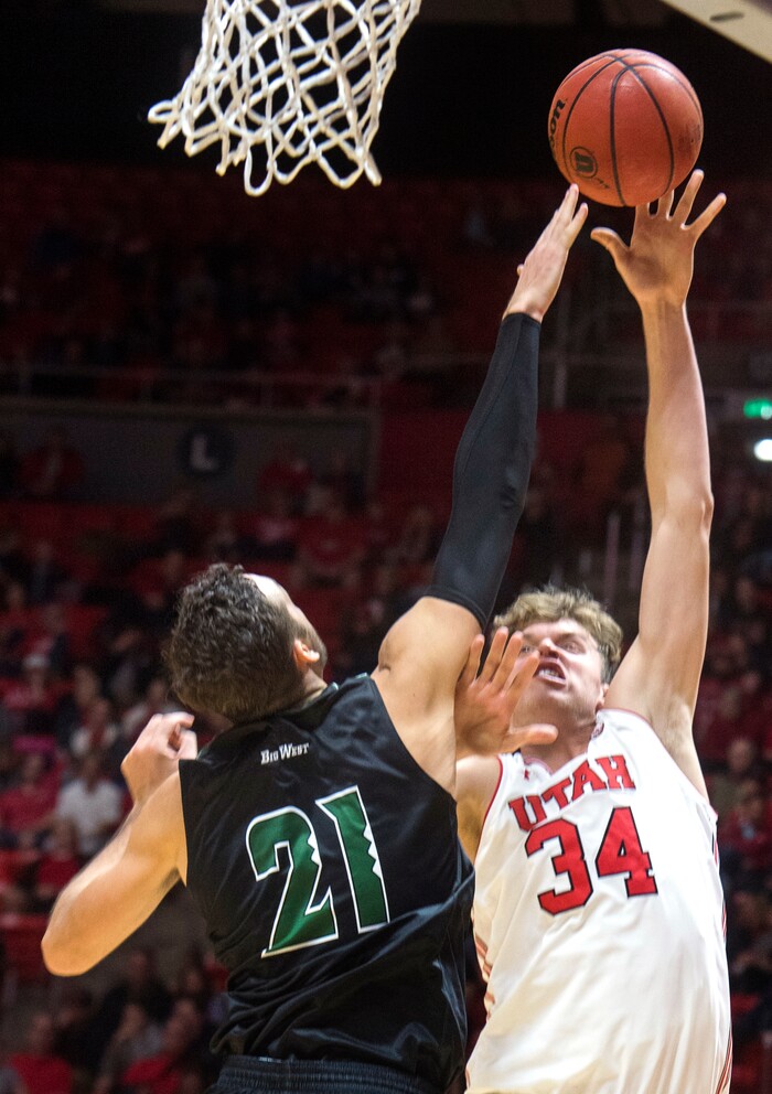 (Rick Egan  |  The Salt Lake Tribune)  Utah Utes forward Jayce Johnson (34) shoots over Hawaii Warriors forward Gibson Johnson (21), in basketball action, Utah Utes vs Hawaii Warriors, at the Jon M. Huntsman Center, Saturday, December 2, 2017.