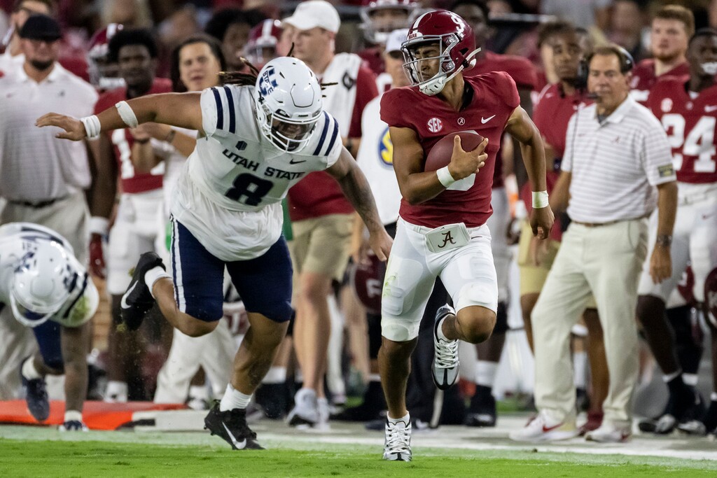 (Vasha Hunt | AP) Alabama quarterback Bryce Young, front right, runs with the ball against Utah State defensive lineman Hale Motu'apuaka (8) during the first half of an NCAA college football game Saturday, Sept. 3, 2022, in Tuscaloosa, Ala.