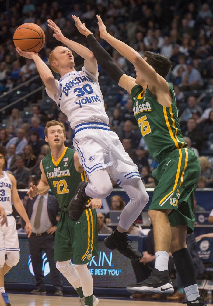 (Rick Egan  |  The Salt Lake Tribune)      Brigham Young Cougars guard TJ Haws (30) shoots over San Francisco Dons center Jimbo Lull (5), in basketball action at the Marriott Center, Saturday, February 10, 2018.