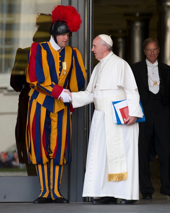 (AP Photo/Alessandra Tarantino, file) In this Oct. 16, 2015, photo, Pope Francis shakes hands with a Vatican Swiss guard as he leaves after a morning session of the Synod of bishops, at the Vatican.