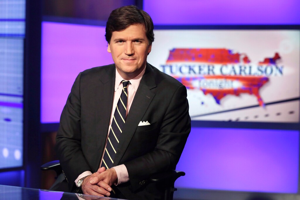 (Richard Drew | AP file photo)  Tucker Carlson, host of "Tucker Carlson Tonight," poses for photos in a Fox News Channel studio, in New York in this March 2, 2017, photo.