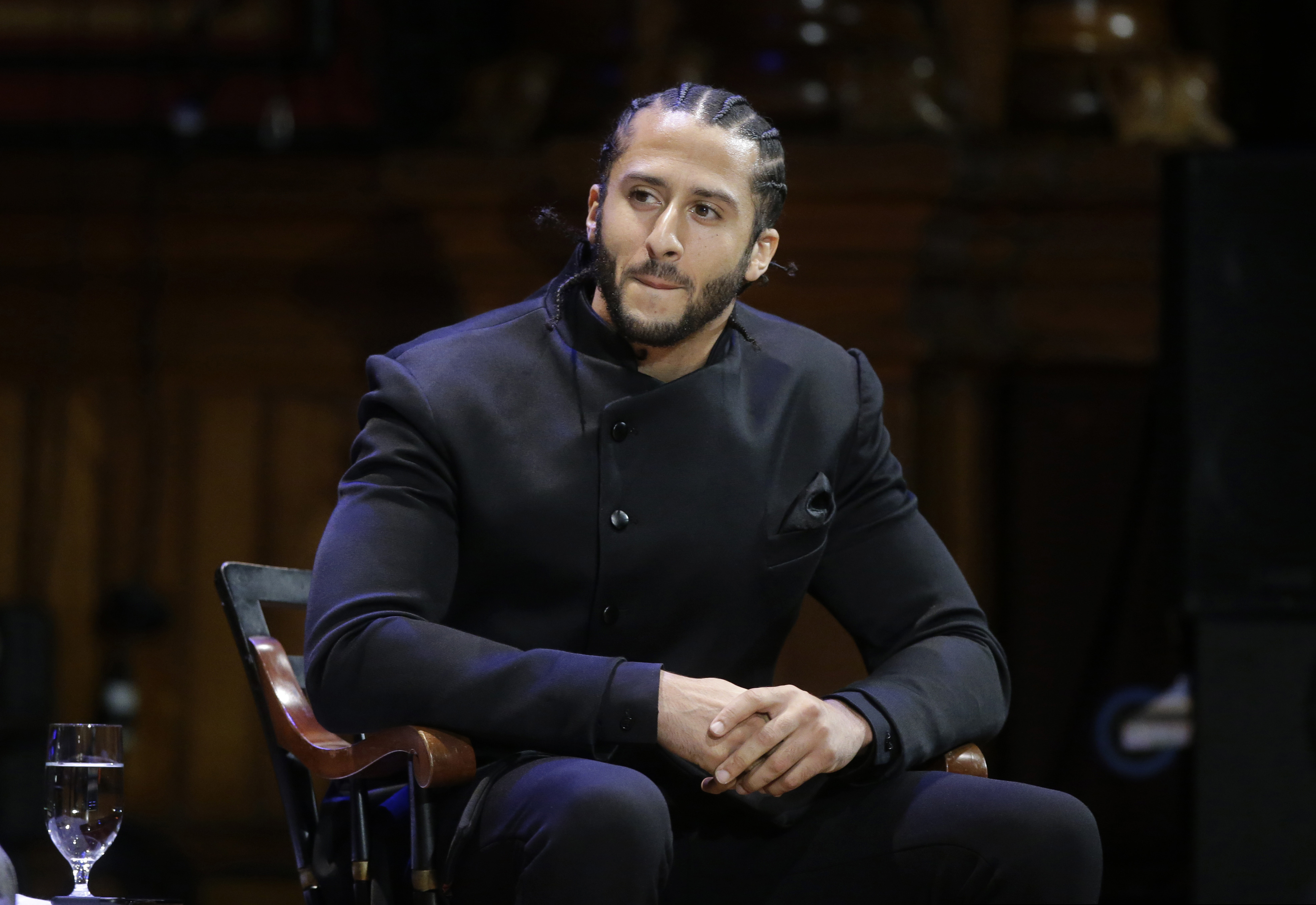 FILE - In this Oct. 11, 2018, file photo, former NFL football quarterback Colin Kaepernick attends the W.E.B. Du Bois Medal ceremonies at Harvard University in Cambridge, Mass. Kaepernick was among eight recipients of Harvard University's W.E.B. Du Bois Medals in 2018. A person with knowledge of the conversation tells The Associated Press that the new Alliance of American Football spoke with Kaepernick during its development about joining the league. But Kaepernick wanted $20 million or more to consider playing with the league that had its debut last weekend. The person spoke on condition of anonymity Thursday because neither side has publicly acknowledged such talks. (AP Photo/Steven Senne, File)