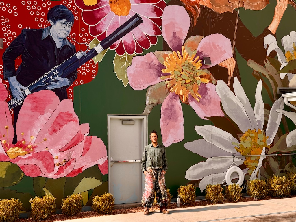 (Mark Eddington | The Salt Lake Tribune) Italian muralist Pepe Gaka stands in front of his artwork in St. George, Thursday, May 22, 2025. The work, featuring floral designs and members of the Southwest Symphony Orchestra, will be formally unveiled Friday, May 23.