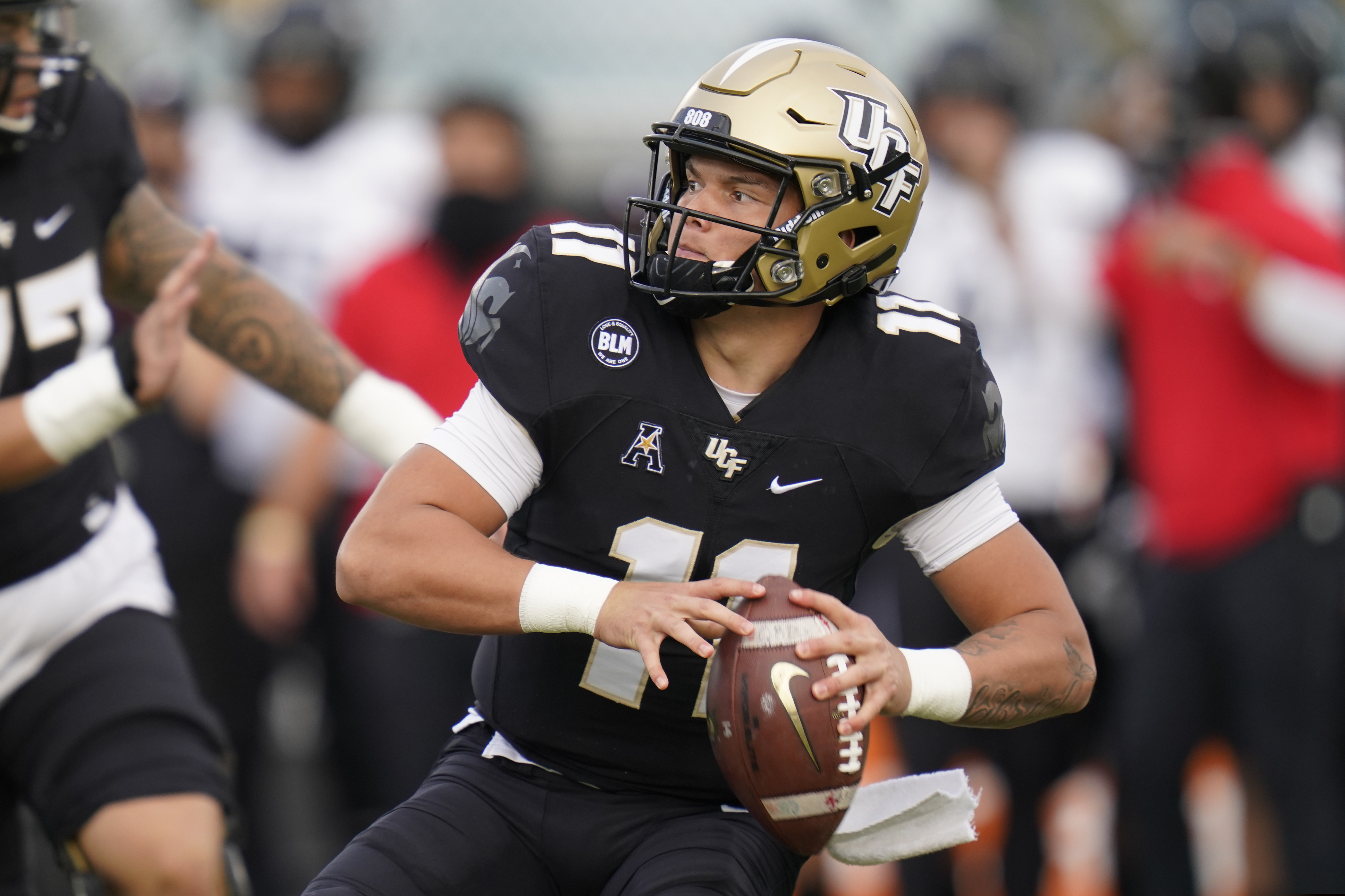 Central Florida quarterback Dillon Gabriel looks for a receiver during the first half of an NCAA college football game against Cincinnati, Saturday, Nov. 21, 2020, in Orlando, Fla. (AP Photo/John Raoux)