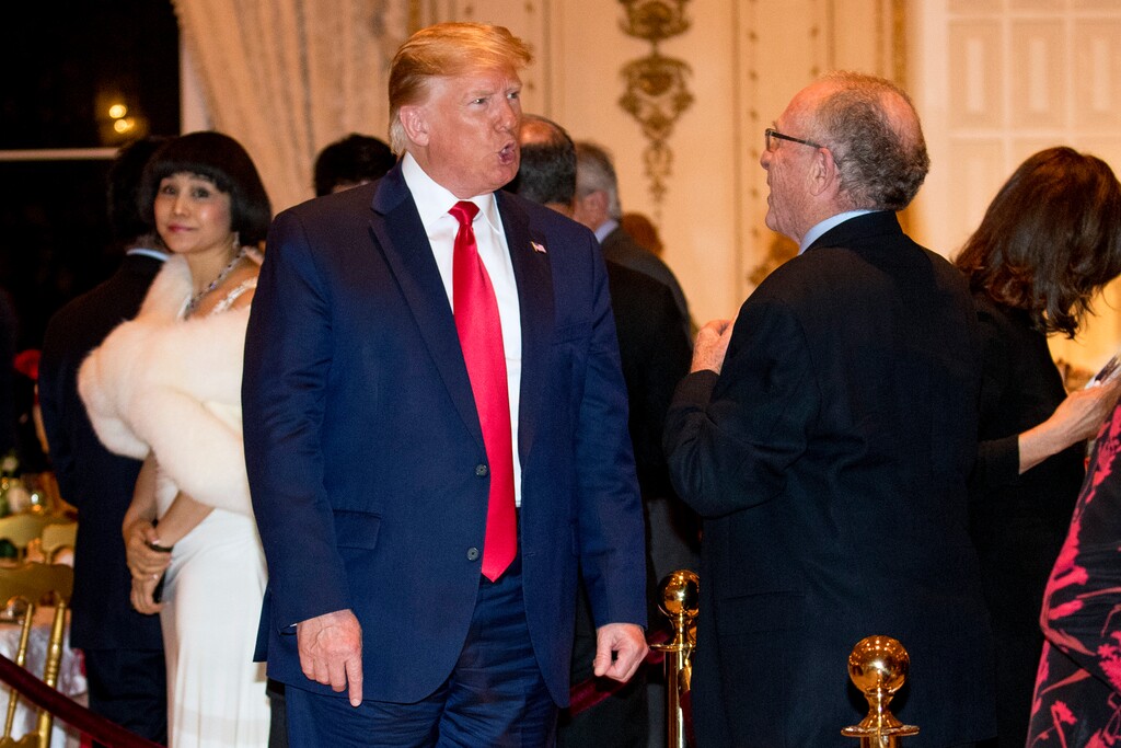 (Andrew Harnik | AP) President Donald Trump speaks to attorney Alan Dershowitz, right, as he arrives for Christmas Eve dinner at Mar-a-lago in Palm Beach, Fla., Tuesday, Dec. 24, 2019.