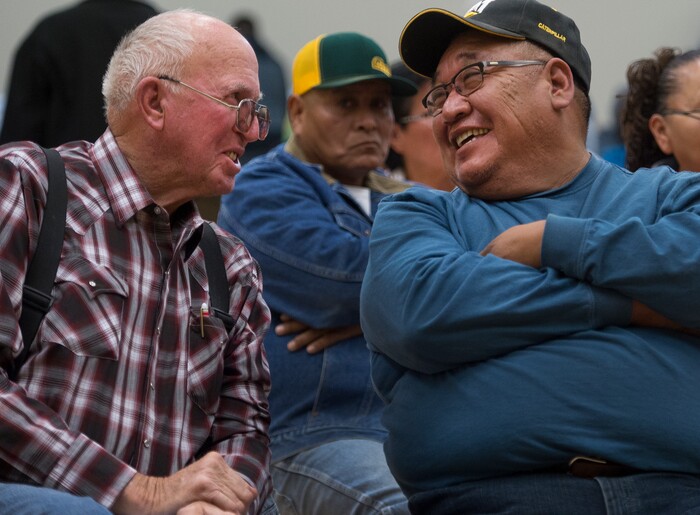 (Leah Hogsten  |  The Salt Lake Tribune) l-r Gary Guymon and Boyd Lopez, a member of the White Mesa Utes, share a laugh during the meeting in Bluff on Thursday. San Juan County residents were presented with proposals of the newly redrawn county commission and school board districts during hearings in Monticello and Bluff, November 16, 2017. The new boundaries could give members of the Navajo Nation a significant majority in two of three commission districts and three of five school board voting districts.