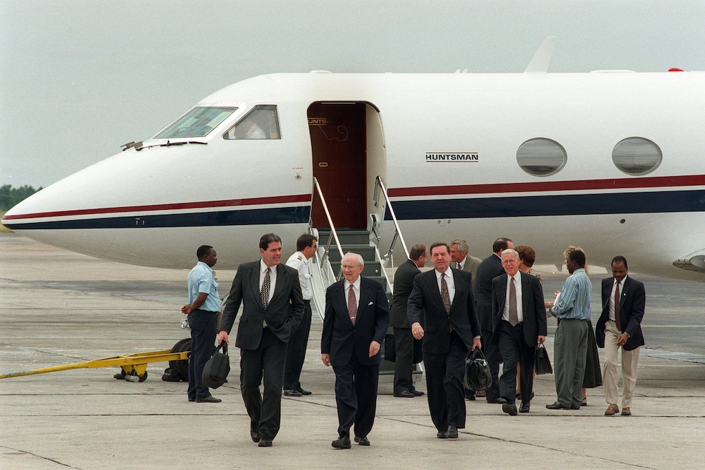 (Trent Nelson  |  The Salt Lake Tribune) Church President Gordon B. Hinckley walks away from a Huntsman jet after arriving in Zimbabwe in 1998. At his left is apostle Jeffrey R. Holland.