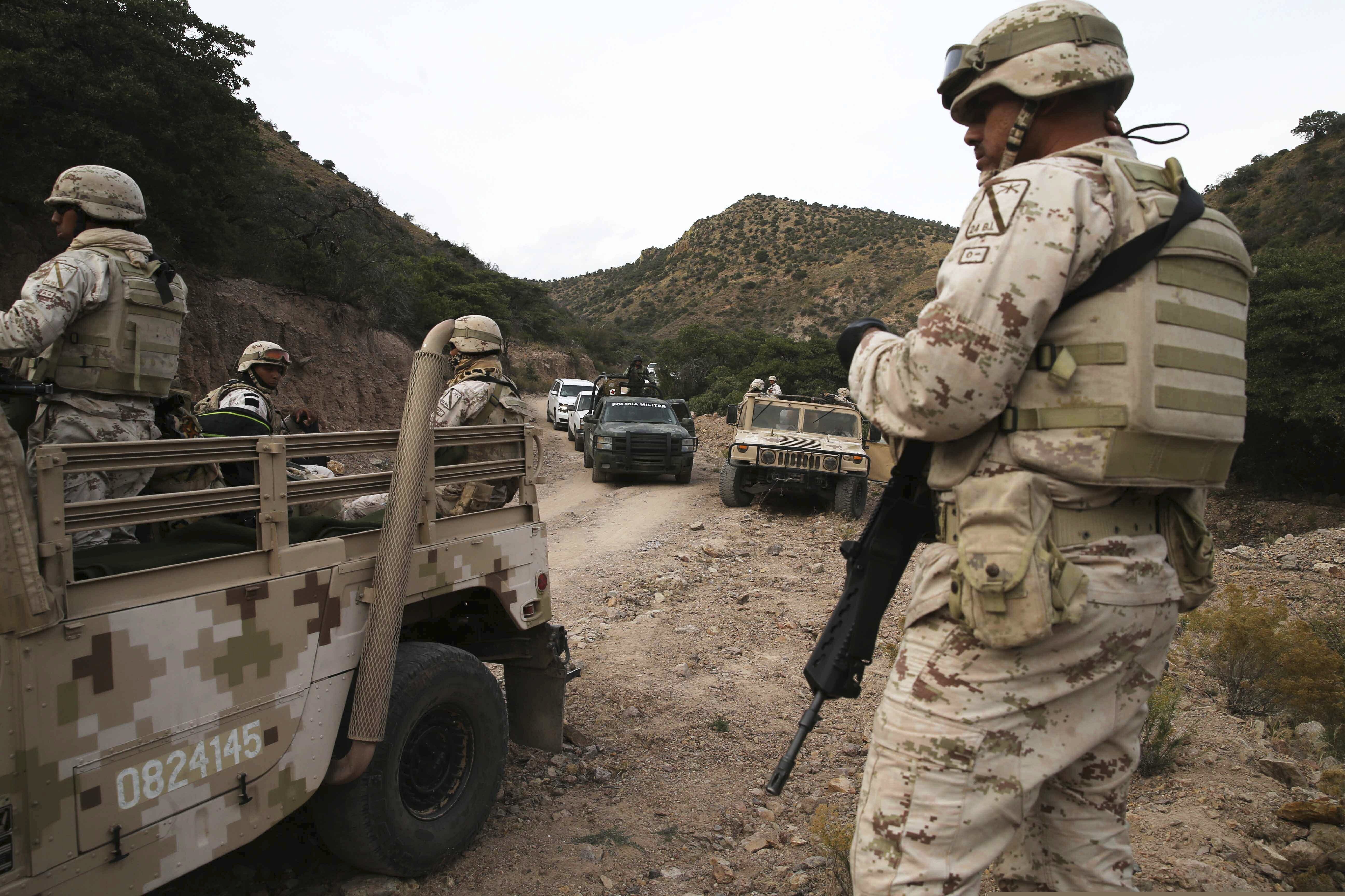 (Marco Ugarte | AP) Heavily armed Mexican authorities guard a caravan of friends and relatives of the LeBaron family as they arrive at the site where nine U.S. citizens, three women and six children related to the extended LeBaron family, were slaughtered when cartel gunmen ambushed three SUVs along a dirt road near Bavispe, at the Sonora-Chihuahua border, Mexico, Wednesday, Nov 6, 2019. Three women and six of their children, related to the extended LeBaron family, were gunned down in an attack while traveling along Mexico's Chihuahua and Sonora state border on Monday.