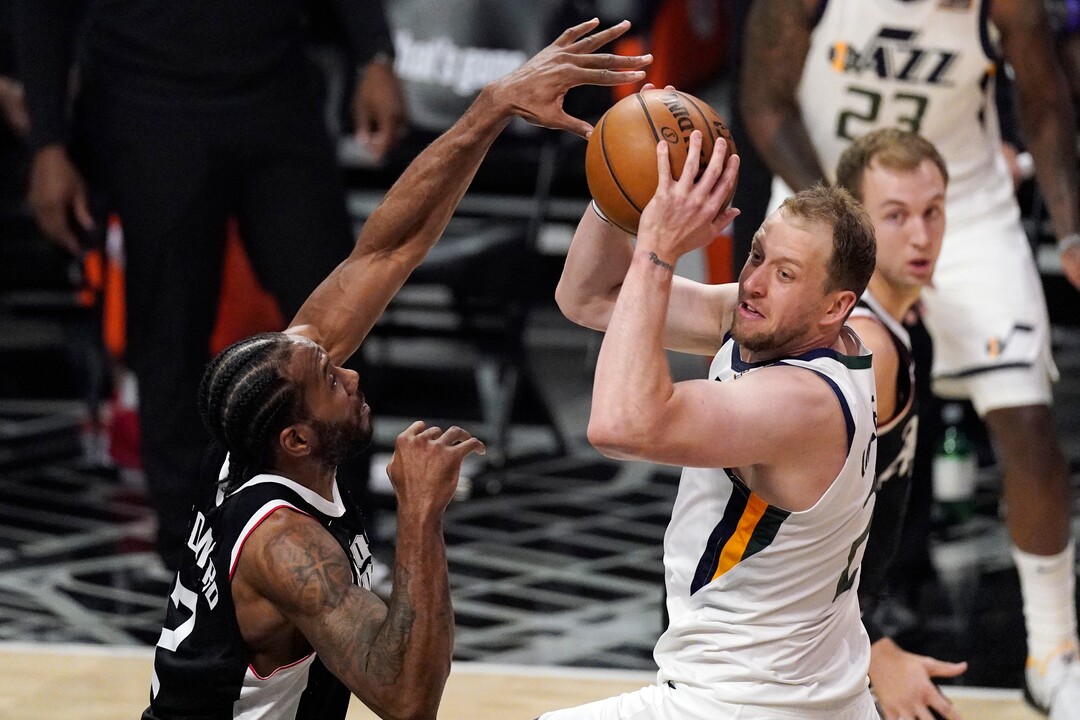 Utah Jazz guard Joe Ingles, right, tries to pass the ball while under pressure from Los Angeles Clippers forward Kawhi Leonard during the second half of Game 3 of a second-round NBA basketball playoff series Saturday, June 12, 2021, in Los Angeles. (AP Photo/Mark J. Terrill)