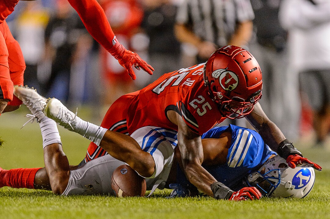 (Trent Nelson | The Salt Lake Tribune)  Utah Utes defensive back Casey Hughes (25) pushes Brigham Young Cougars running back Trey Dye (4) into the ground as BYU hosts Utah, NCAA football in Provo, Saturday September 9, 2017.