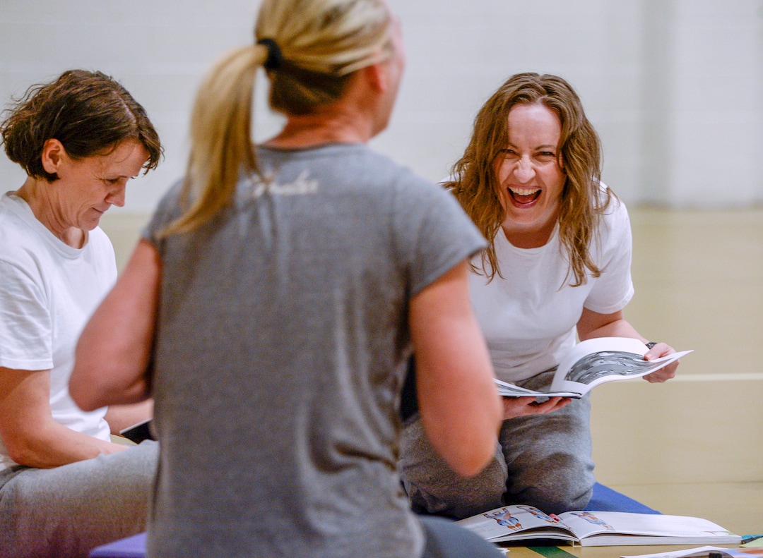 Leah Hogsten  |  The Salt Lake Tribune  l-r Yoga instructor apprentice Jeanne Mace and Caroline Ashby giggle with their lead yoga instructor Denise Druce, center, during instructional training. Druce began volunteering at Timpanogos WomenÕs Correctional Facility in December 2017 and is now teaching a group of  four women how to lead their own classes and become yoga instructors. Every Friday, the Timpanogos Women's Correctional Facility gymnasium at the Utah State Prison is filled with a joyful silence as inmates practice yoga.