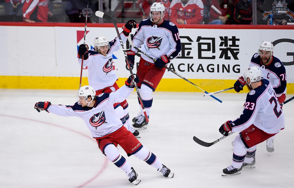 Columbus Blue Jackets left wing Artemi Panarin, front, of Russia, celebrates his game-winning goal with Cam Atkinson (13), Nick Foligno (71), Ian Cole (23) and Pierre-Luc Dubois (18) during overtime in Game 1 of an NHL first-round hockey playoff series against the Washington Capitals, Thursday, April 12, 2018, in Washington. The Blue Jackets won 4-3. (AP Photo/Nick Wass)