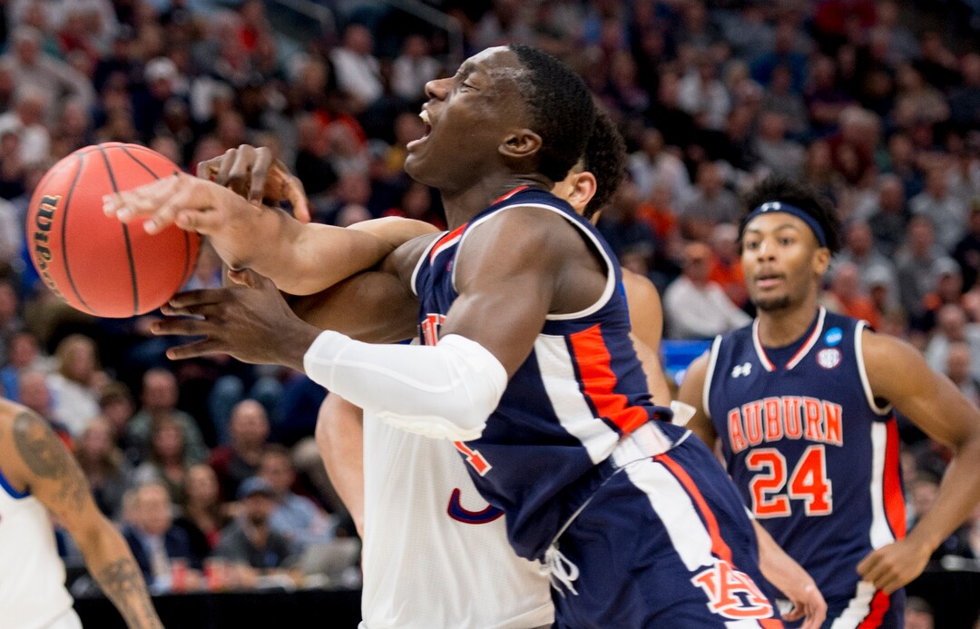 (Leah Hogsten  | The Salt Lake Tribune)  Auburn Tigers guard Jared Harper (1) gets tangled up with Kansas Jayhawks guard Quentin Grimes (5) as Auburn faces Kansas in the second round of the NCAA tournament in Salt Lake City on Saturday, March 23, 2019.