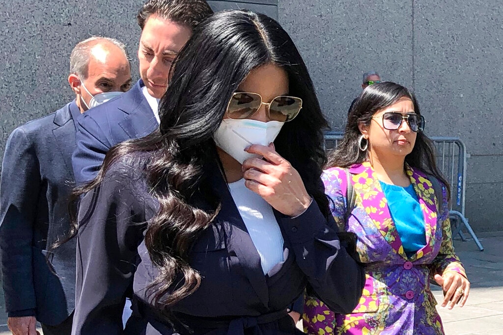 (Lawrence Neumeister | AP) Jennifer Shah, center, of "The Real Housewives of Salt Lake City," touches her face mask as she leaves Manhattan federal court after pleading guilty to wire fraud conspiracy in New York, Monday July 11, 2022.