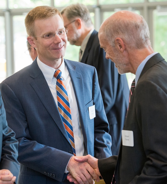 (Rick Egan  |  The Salt Lake Tribune)  Nathan Adams shakes hands with Robert Paine III  as the University of Utah named Adams and Paine as two of the six new Jon M. Huntsman Presidential Chairs, funded by the Huntsman Family Foundation, during a ceremony at the Alumni House, Tuesday, June 19, 2018.


